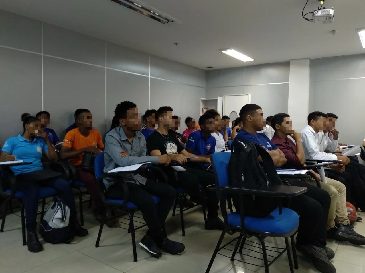 Group of students in a classroom watching a presentation.